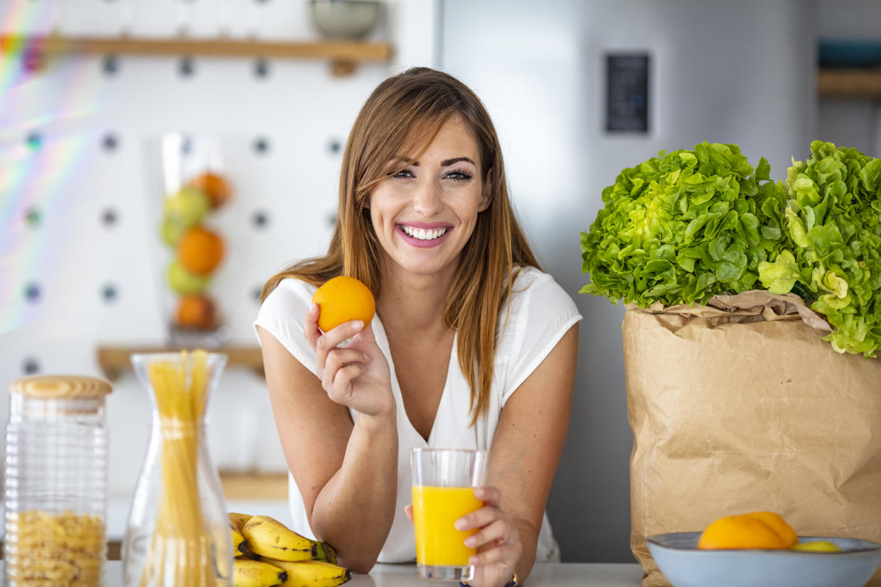 Woman preparing freshly squeezed orange juice. (Getty Images)