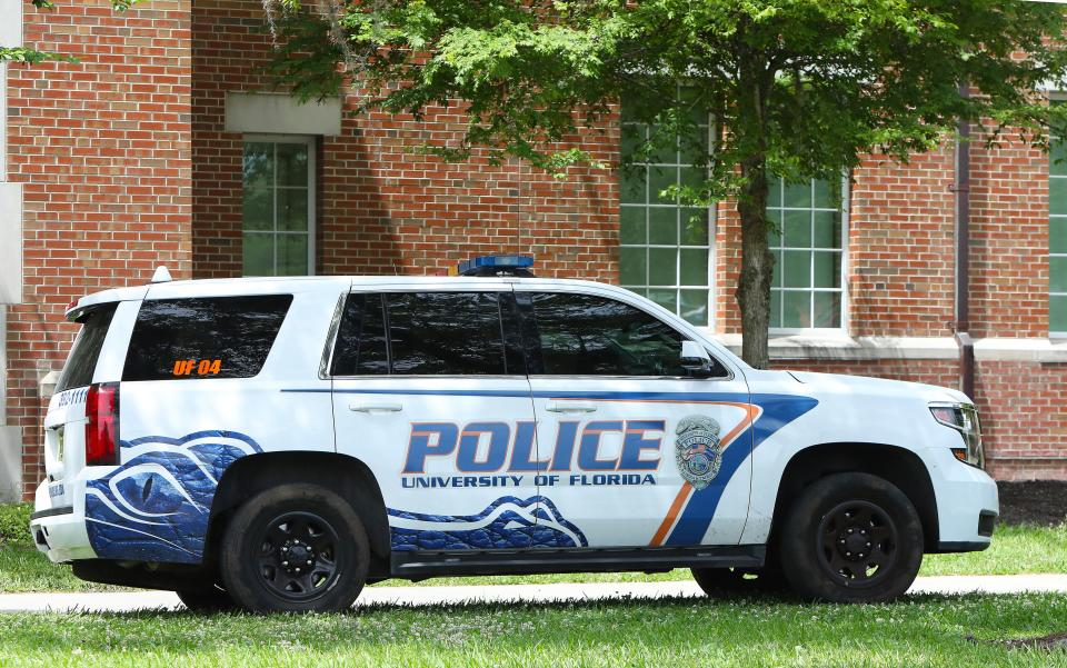 A University of Florida Police vehicle drives on the grass near Northwest 13th Street and Heavener Hall on the UF campus, in Gainesville Fla. April 13, 2022.