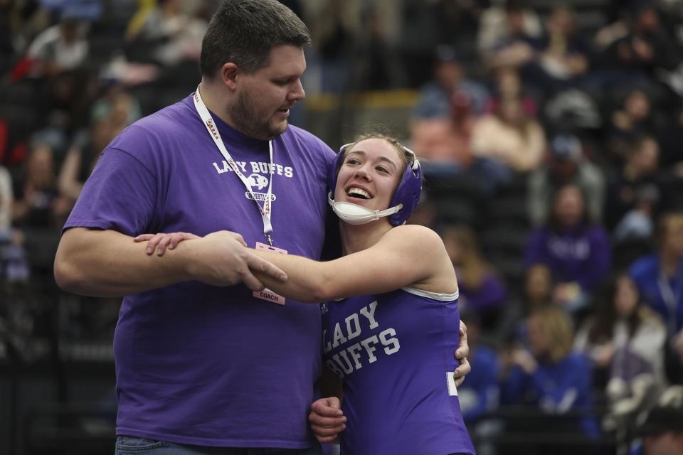 Tooele’s Anna Chlarson is congratulated by her coach Joel Spendlove after Chlarson beat Ridgeline’s Taya Crookston with a double chicken wing at the 4A State Championships at Utah Valley University in Orem on Wednesday, Feb. 14, 2024. | Laura Seitz, Deseret News