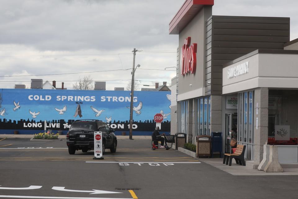 Tops Friendly Market on Jefferson Ave. in Buffalo is busy with customers.  Across the street is a memorial for the 10 people killed inside and outside Tops by a white gunman looking to kill Black people.