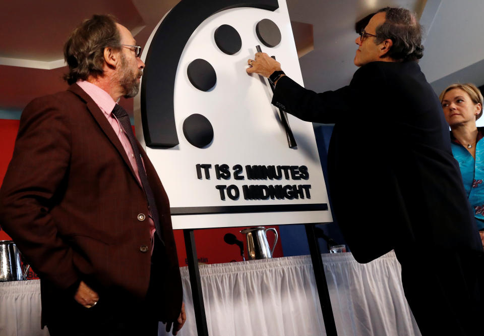 Members of the Bulletin of the Atomic Scientists, (L-R), Lawrence Krauss, Robert Rosner and Sharon Squassoni move the 'Doomsday Clock' hands to two minutes until midnight at a news conference in Washington, U.S. January 25, 2018. REUTERS/Leah Millis