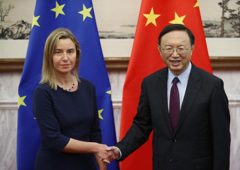 EU foreign policy chief Federica Mogherini (L) shakes hands with China's State Councilor Yang Jiechi in Beijing on May 5, 2015
