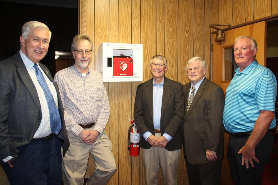 Berlin Lions Club members (from left) Doug Bell, Ron Yoder, Bill Landis, Kerry Claycomb and John Hartman stand by one of the many Automated External Defibrillators (AED) of the type supplied to the local area by the Berlin Lions in case of cardiac arrest emergencies.