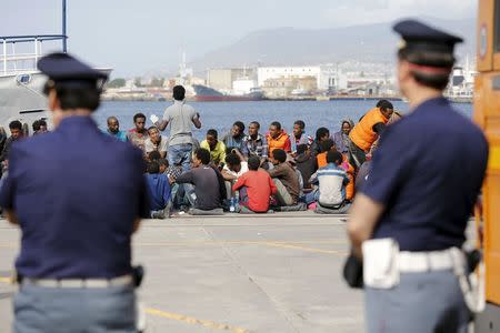 Migrants are disembarked from the Migrant Offshore Aid Station (MOAS) ship MV Phoenix in the Sicilian harbour of Messina, Italy May 16, 2015. REUTERS/Antonio Parrinello