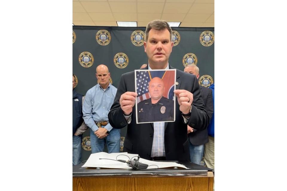 An official shows a picture of the killed deputy, Greg McCowan, during a press conference (Blount County Sheriff's Office)