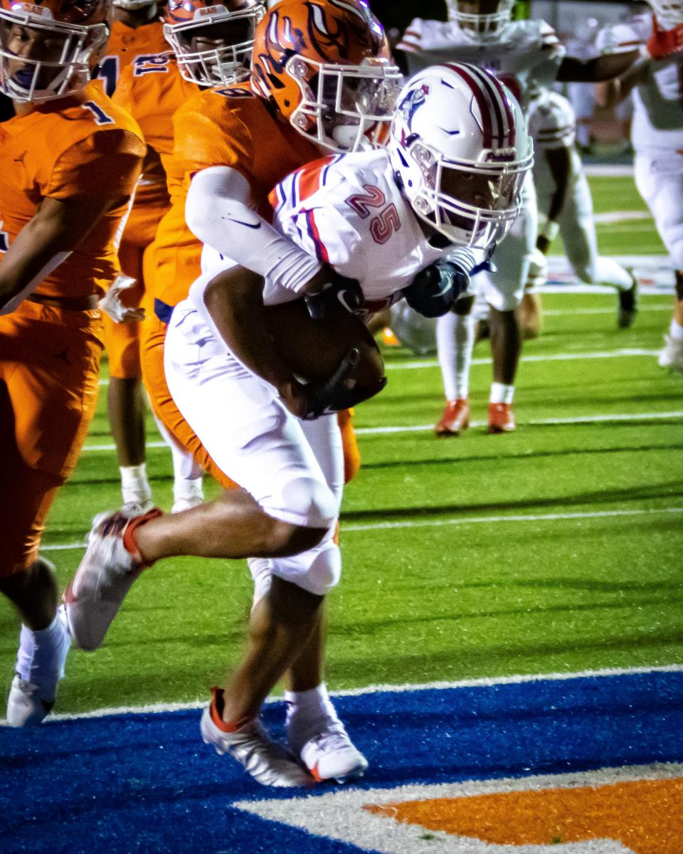 Oakland's T.T. Hill gets into the end zone as Blackman's Anthony Hernandez tries to bring him down during Friday's Region 4-6A game at Blackman. The Patriots won 53-18.