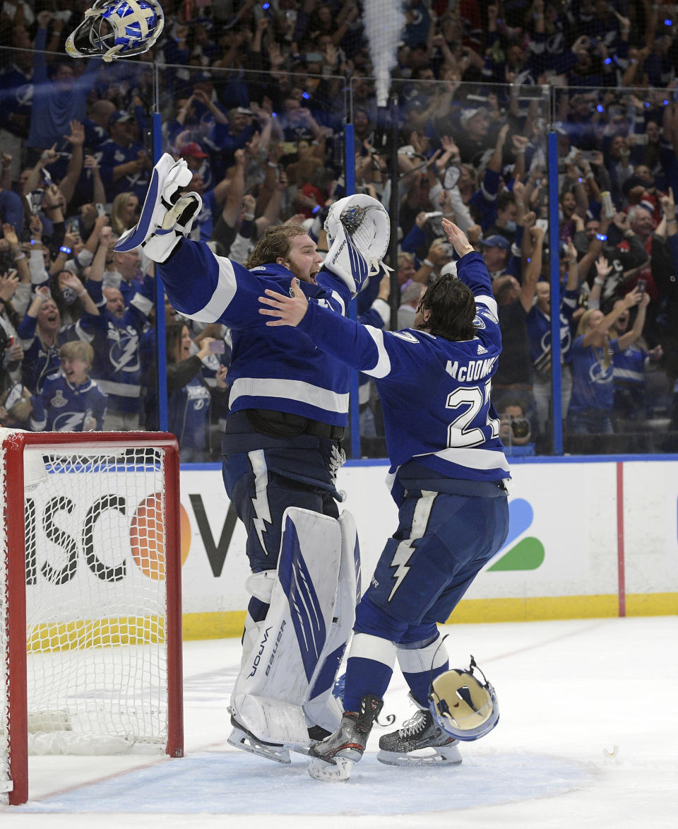 FILE - In this July 7, 2021, file photo, Tampa Bay Lightning defenseman Ryan McDonagh (27) and goaltender Andrei Vasilevskiy (88) celebrate the team's Stanley Cup series win in Game 5 of the NHL hockey finals in Tampa, Fla. (AP Photo/Phelan Ebenhack, File)