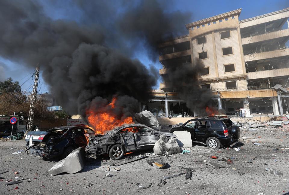 Cars burn at the site of an explosion, in the suburb of Beir Hassan, Beirut, Lebanon, Wednesday Feb. 19, 2014. (AP Photo/Hussein Malla)