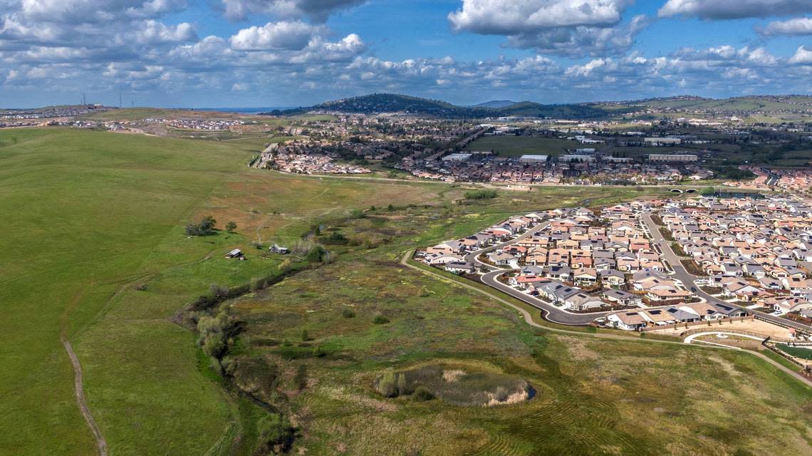 Newly built homes stand in El Dorado Hills last month near land owned by Angelo Tsakopoulos that is proposed for development. Hector Amezcua/hamezcua@sacbee.com