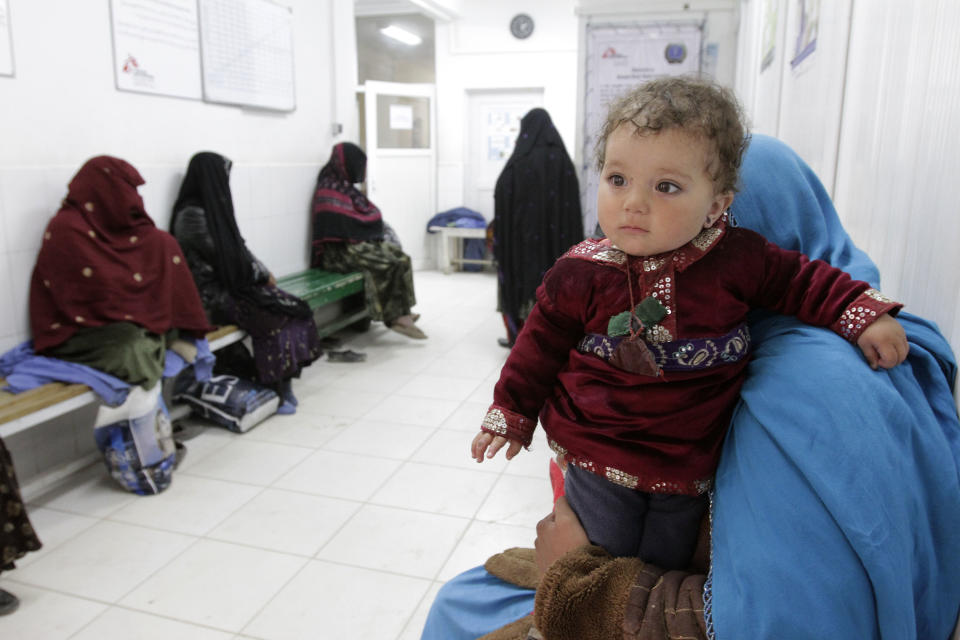 Relatives and caretakers of women in labor wait outside the delivery rooms at Ahmad Shah Baba District Hospital in Kabul, Afghanistan on Monday, Feb. 24. 2014. (AP Photo/Cassandra Vinograd)