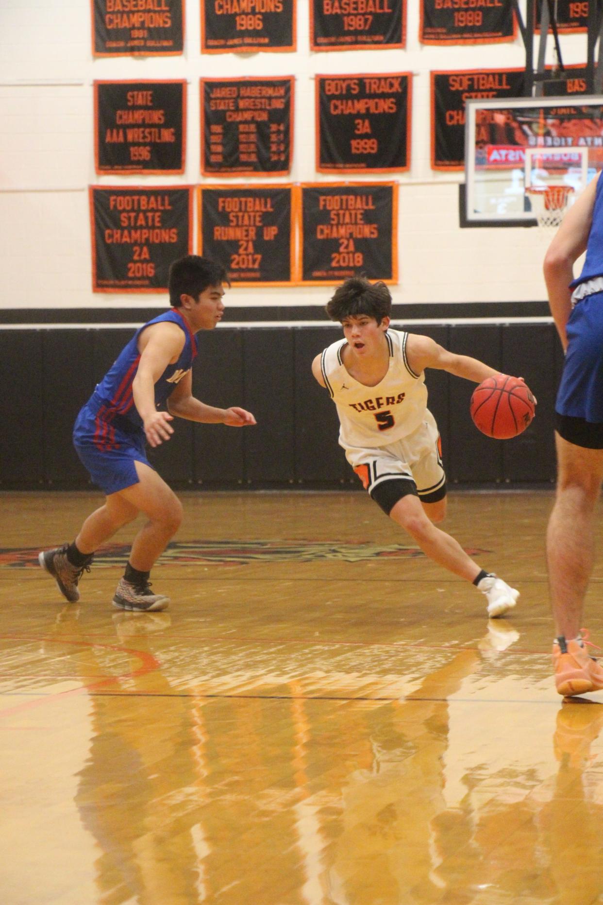 Ethan Leyba drives past a a Buena Vista defender Friday evening in La Junta. Leyba scored nine points in the Tiger's 53-49 victory.