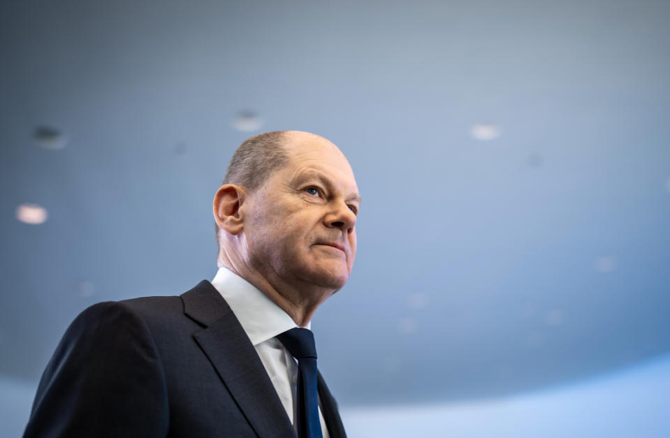 FILE - German Chancellor Olaf Scholz leaves after a news conference, ahead of a one-day closed meeting of the German Cabinet at the Chancellery in Berlin, Germany, Friday, Jan. 21, 2022. Scholz is flying to Washington this week to reassure Americans that his country stands alongside the United States and other NATO partners in opposing any Russian aggression against Ukraine. Scholz has publicly said that Moscow would pay a “high price” in the event of an attack. But his government’s refusal to supply lethal weapons to Ukraine, bolster its troop presence in eastern Europe or spell out which sanctions it would support against Russia has drawn criticism abroad and at home. (Michael Kappeler/Pool via AP, File)