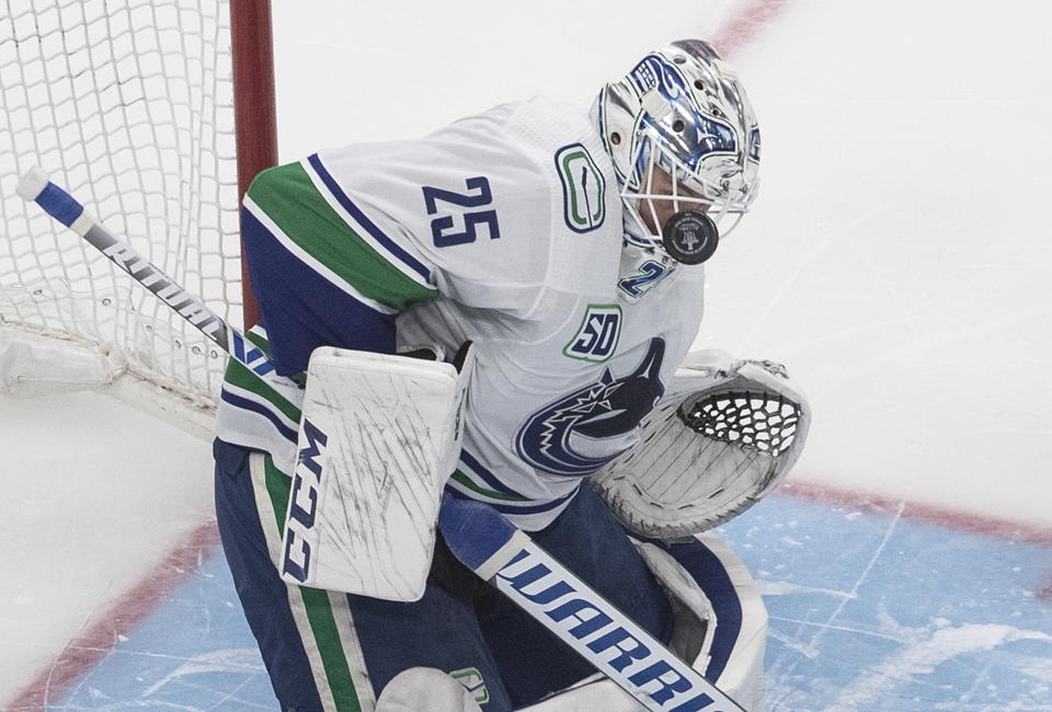 Vancouver Canucks goalie Jacob Markstrom (25) makes a save against the St. Louis Blues during the second period of a first-round NHL Stanley Cup playoff hockey series in Edmonton, Alberta, Friday Aug. 14, 2020. (Jason Franson/The Canadian Press via AP)