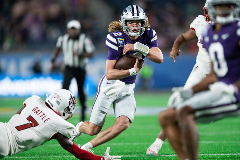 December 28, 2023;  Orlando, Florida, USA;  Kansas State quarterback Avery Johnson (2) runs for the touchdown against NC State in the second quarter at Camping World Stadium.  Mandatory Credit: Jeremy Reper-USA TODAY Sports