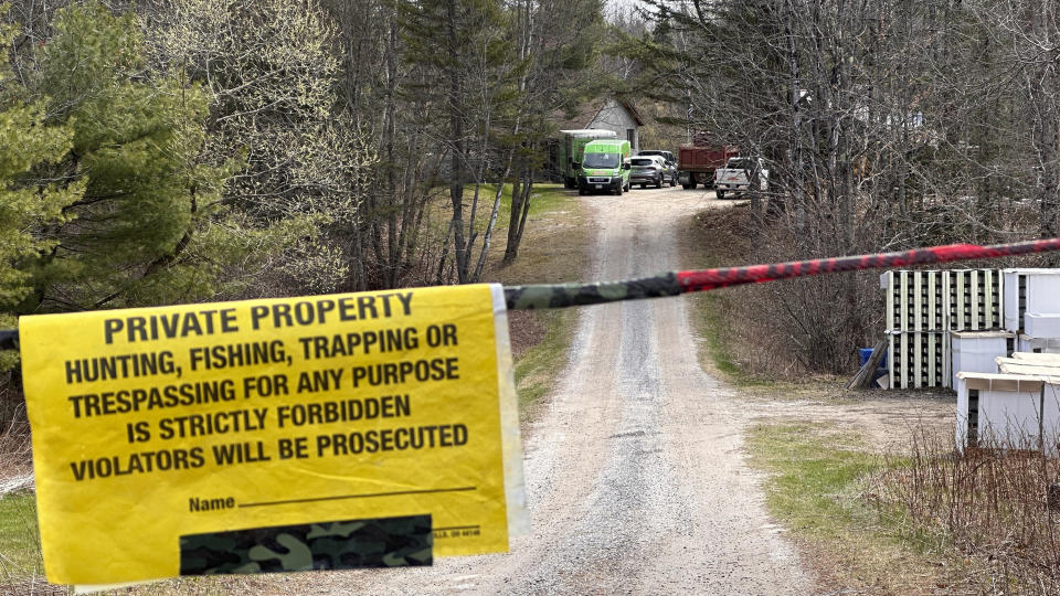 A crime-scene cleaning crew is seen down the driveway at a home in Bowdoin, Maine, Friday, April 21, 2023, after four people were shot and killed there several days earlier. The deaths shook the area and brought the national spate of mass gunfire home to a rural community where violent crime is rare. (AP Photo/Rodrique Ngowi)