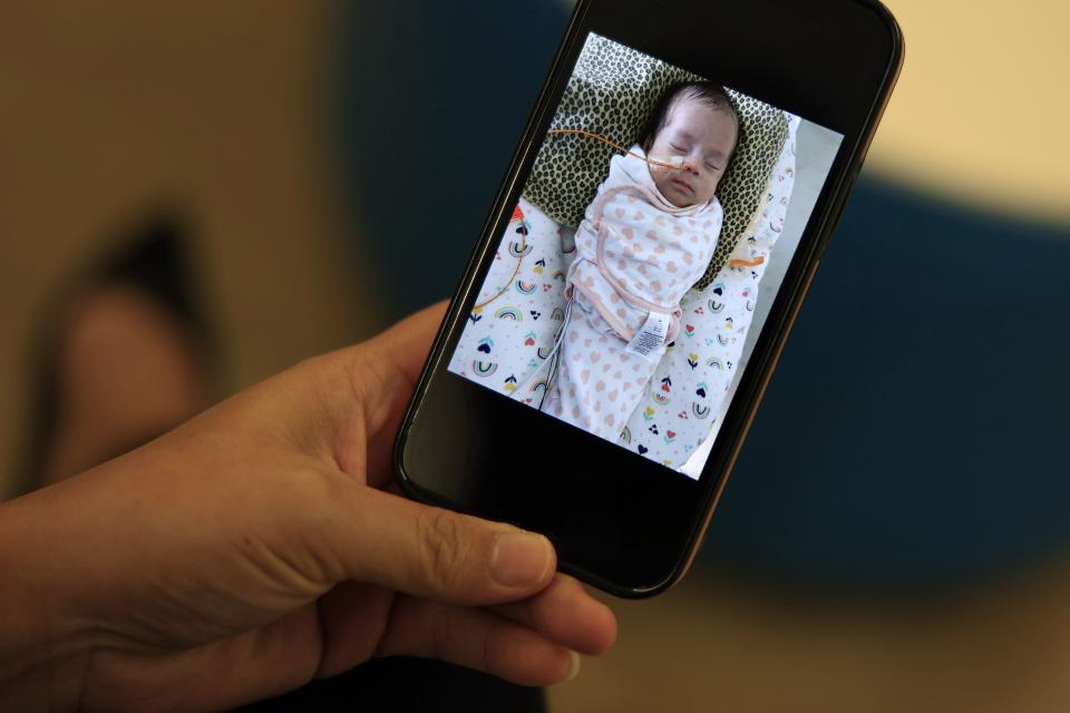 Erika Lamas shows a picture of her daughter, Aria, a triplet born at Wolfson Children's Hospital. The children were the first to be transferred to the new Borowy Family Children's Critical Care Tower. Aria's sisters have gone home already, and Lamas hopes that Aria will be able to join them soon.