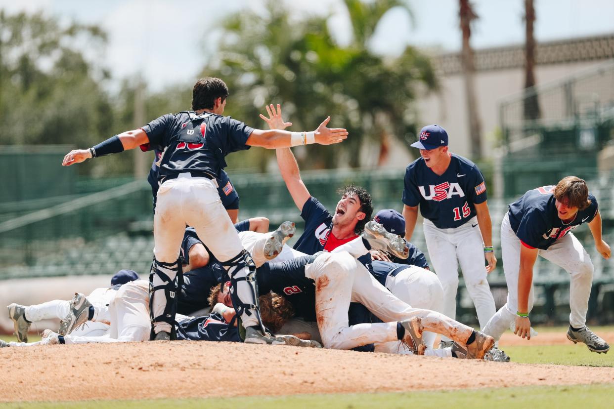 Members of the USA U18 baseball team celebrate winning the  WBSC Baseball 18U World Cup on Sunday at Ed Smith Stadium in Sarasota.