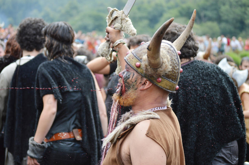 A man wears a Vikin Helmet in a gathering