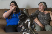 Oriana Hernandez, left, and Mercedes Ramos become emotional at their home while talking about Jerry Ramos, 32, in Watsonville, Calif., Sunday, June 6, 2021. Hernandez's boyfriend and Mercedes Ramos' son Jerry Ramos died Feb. 15 at age 32, becoming not just one of the roughly 600,000 Americans who have now perished in the outbreak but another example of the virus's strikingly uneven and ever-shifting toll on the nation's racial and ethnic groups. (AP Photo/Nic Coury)