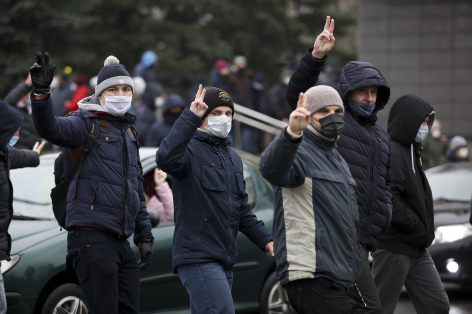 Demonstrators wearing face masks to help curb the spread of the coronavirus gesture during an opposition rally to protest the official presidential election results in Minsk, Belarus, Sunday, Nov. 22, 2020. The Belarusian human rights group Viasna says more than 140 people have been arrested and many of them beaten by police during protests calling for the country's authoritarian president to resign. The demonstrations that attracted thousands were the 16th consecutive Sunday of large protests against President Alexander Lukashenko. (AP Photo)