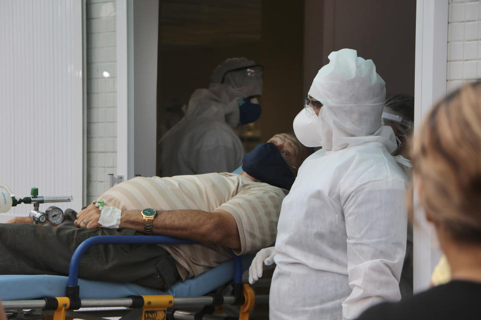 In this April 16, 2020 photo, a man suspect on suffering COVID-19 disease, waits on a stretcher to be allowed into the 28 de Agosto hospital in Manaus, Amazonas state, Brazil. Amazonas state had more than 2,000 confirmed COVID-19 cases as of Sunday April 19, the vast majority in Manaus, the only city in the state with intensive care units. (AP Photo/Edmar Barros)