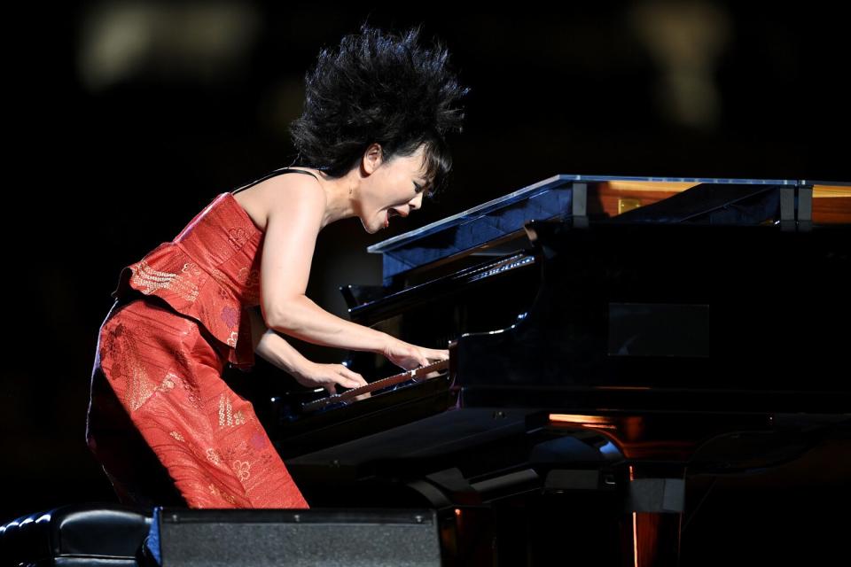 A Japanese jazz composer Hiromi Uehara plays the piano during the Opening Ceremony