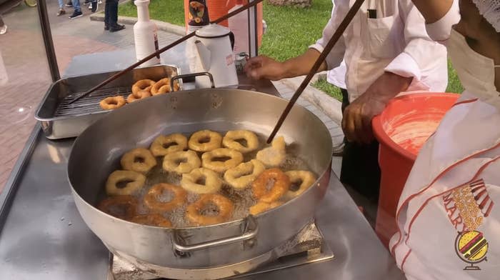 Picarones cooking in a large pan