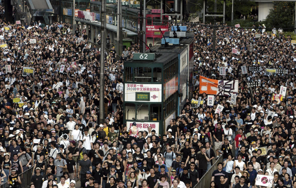In this July 1, 2003, file photo, tens of thousands of people pack a Hong Kong street while marching to Hong Kong government headquarters to protest the Hong Kong government's plans to enact an anti-subversion bill that critics fear will curtail civil liberties. A national security law enacted in 2020 and COVID-19 restrictions have stifled major protests in Hong Kong including an annual march on July 1. (AP Photo/Vincent Yu, File)
