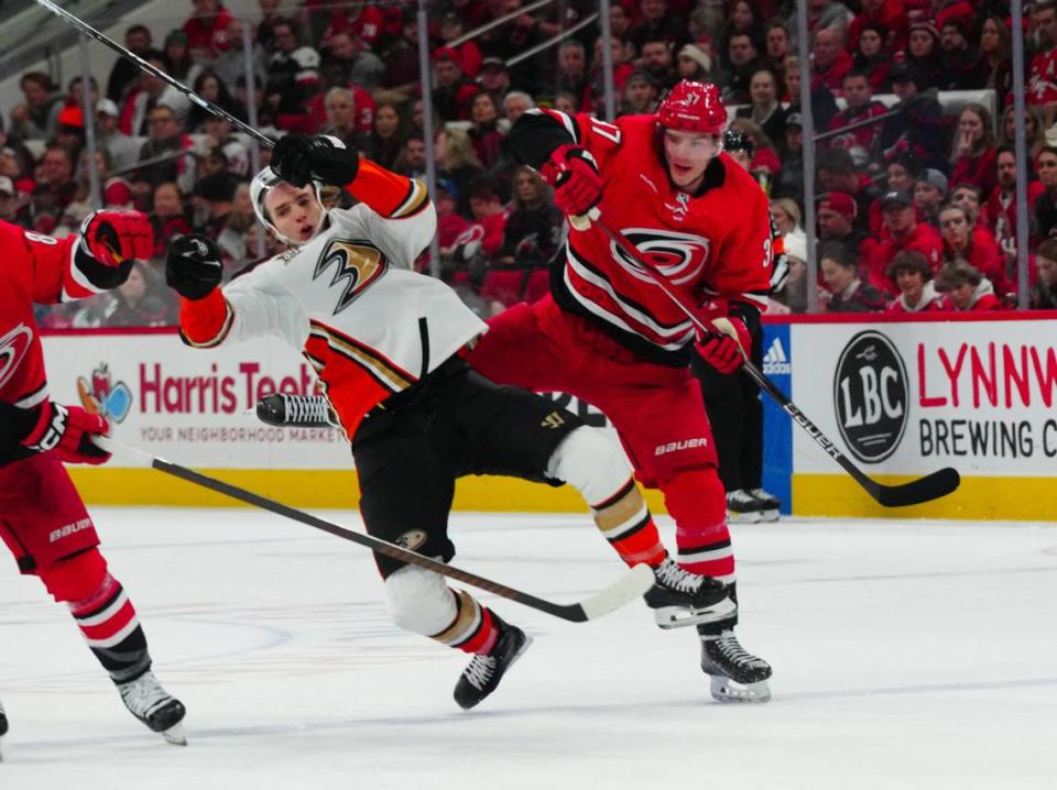 Jan 11, 2024; Raleigh, North Carolina, USA; Carolina Hurricanes right wing Andrei Svechnikov (37) checks Anaheim Ducks left wing Alex Killorn (17) during the second period at PNC Arena. Mandatory Credit: James Guillory-USA TODAY Sports