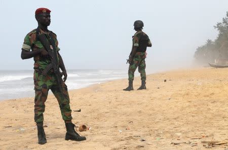 Soldiers stand guard on the beach following an attack by gunmen from al Qaeda's North African, in Grand Bassam, Ivory Coast, March 14, 2016. REUTERS/Luc Gnago