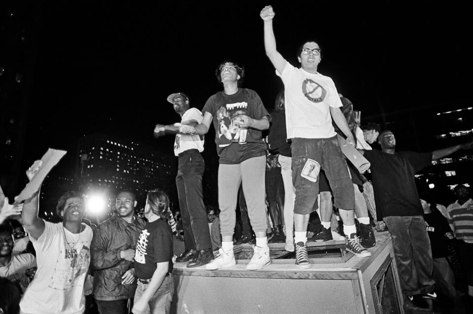 People in Los Angeles overturn a parking kiosk and set it on fire in protest of the acquittal of the LAPD officers who beat Rodney King. (Photo: Ted Soqui/Getty Images)