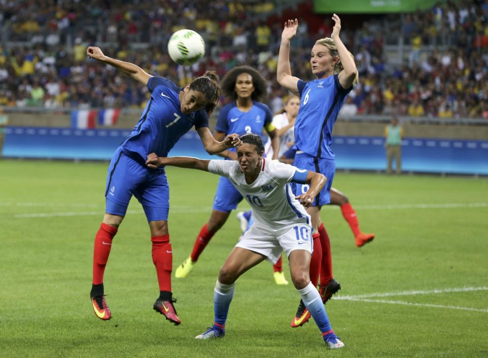 <p>Carli Lloyd (USA) of U.S. in action with Amel Majri (FRA) and Amandine Henry (FRA) of France. REUTERS/Mariana Bazo </p>