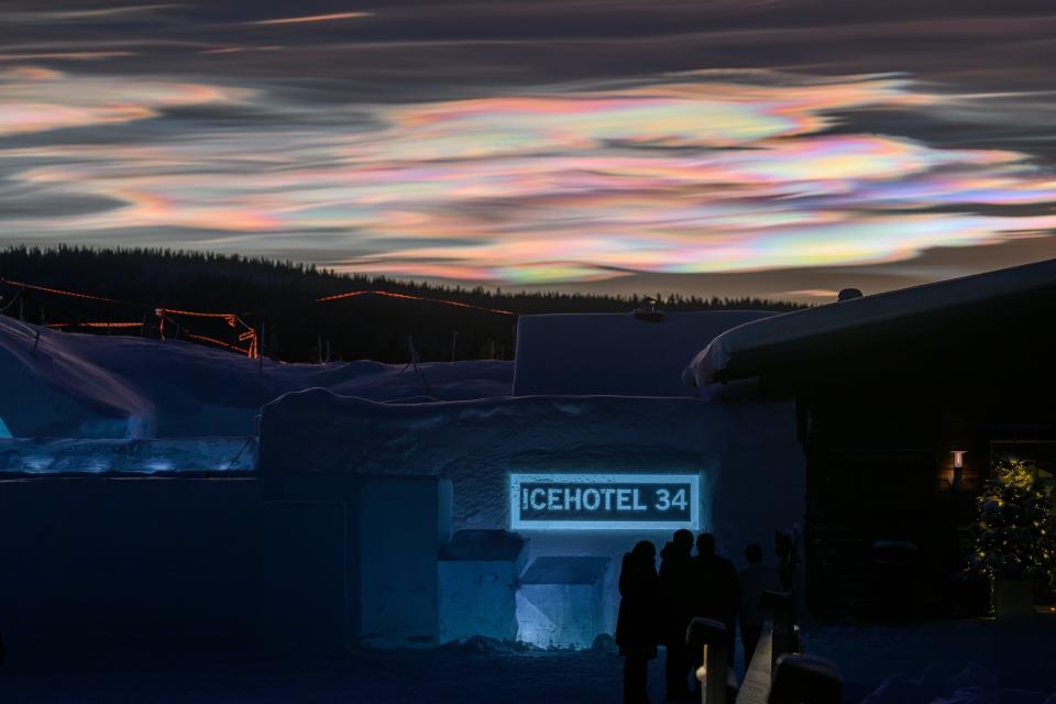 Rainbow-colored clouds can be seen scattered in the sky.