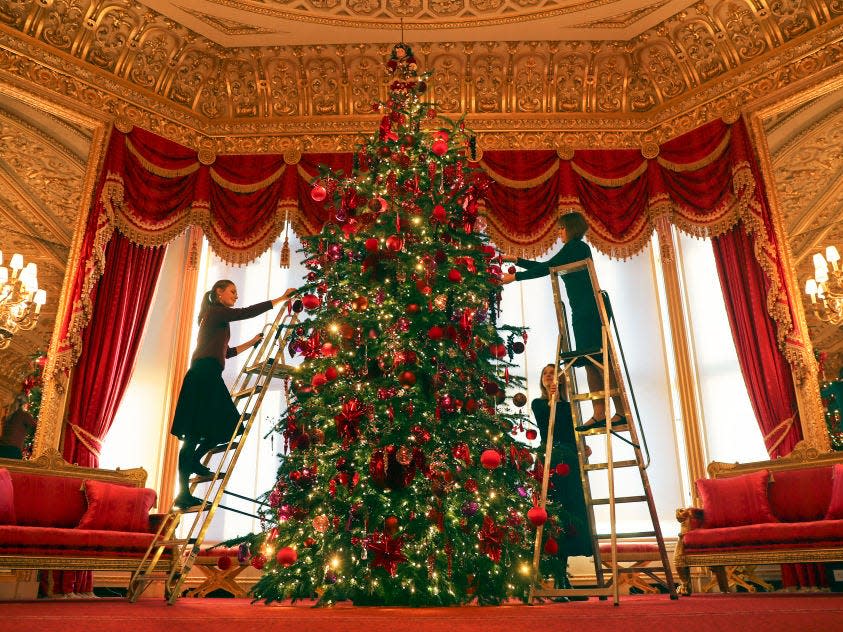 Decorating a tree in the Crimson Drawing Room.