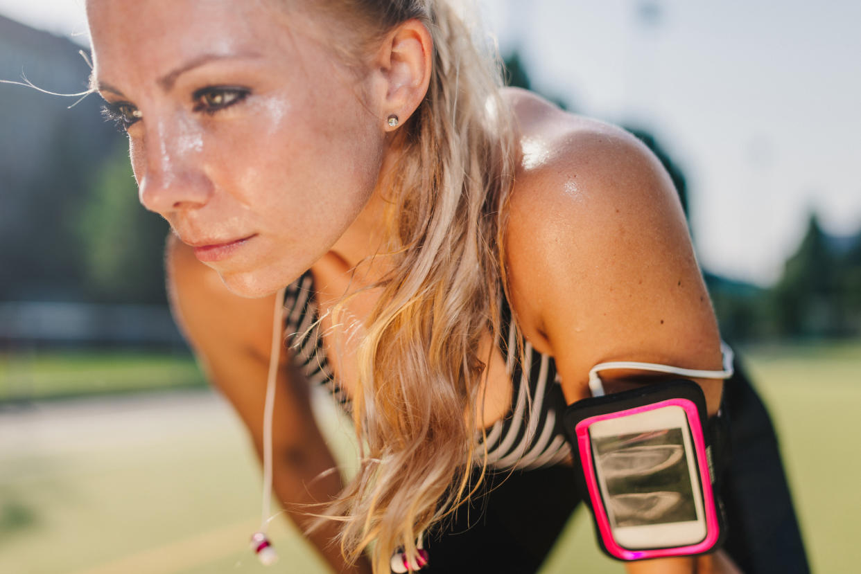 Blonde woman resting after exercising in field