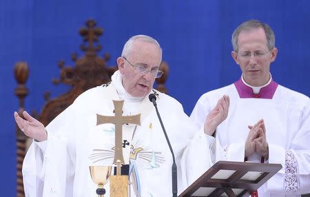 Pope Francis (L) takes part in the Holy Mass at Daejeon World Cup stadium in Daejeon August 15, 2014. REUTERS/Korea Pool/News1