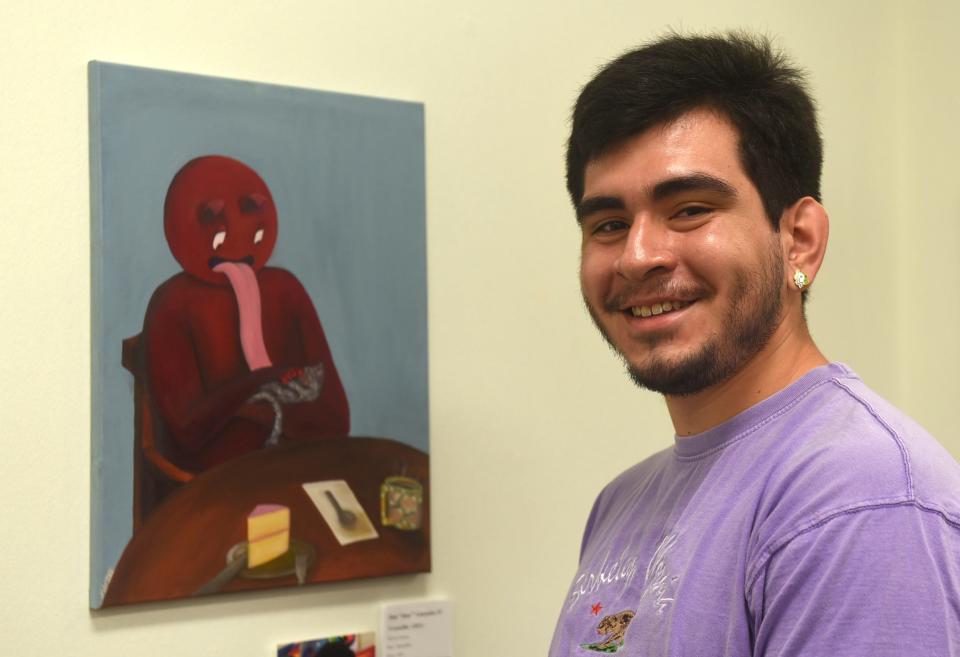 Jose "Joey" Gonzales IV organizes La Palmera's first Pride exhibit, Thursday, June 24, 2021. Gonzales also shows three of his own pieces, including "Cortadillo" as seen in the background.