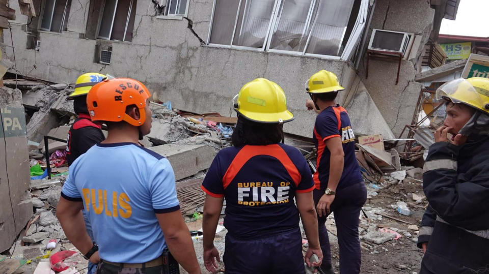 Residents and rescuers check damaged structures following an earthquake that struck Padada, Davao del Sur province, southern Philippines on Sunday Dec. 15, 2019. A strong quake jolted the southern Philippines on Sunday, causing a three-story building to collapse and prompting people to rush out of shopping malls, houses and other buildings in panic, officials said. (AP Photo)