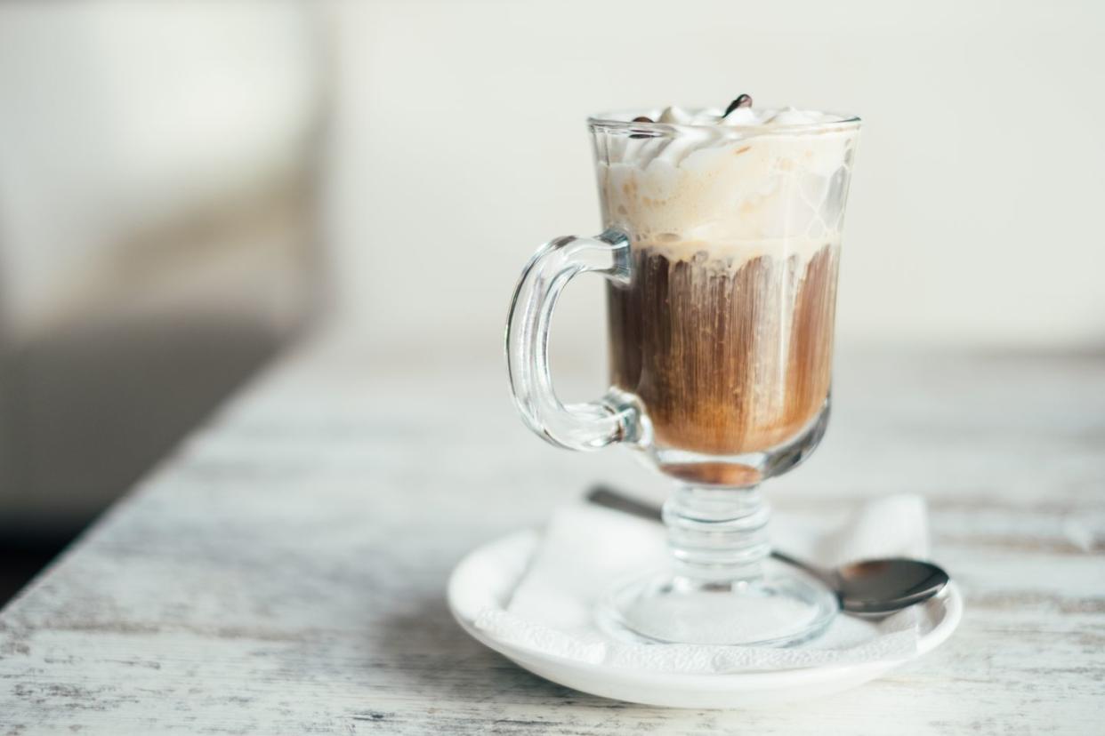 close up of an irish coffee on a wooden table