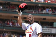 St. Louis Cardinals' Albert Pujols tips his cap after hitting a grand slam during the third inning of a baseball game against the Colorado Rockies Thursday, Aug. 18, 2022, in St. Louis. (AP Photo/Jeff Roberson)