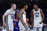Michigan State's A.J. Hoggard, center, celebrates with teammates Joey Hauser (10) and Julius Marble II (34) during the first half of an NCAA basketball game against Kansas Tuesday, Nov. 9, 2021, in New York. (AP Photo/Frank Franklin II)