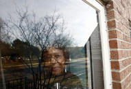 Lorene Parker watches outside through a window at her house, which is in foreclosure in Detroit, Michigan December 11, 2008. Parker of Detroit fell behind on her mortgage with Bank of America when she had large medical bills from heart and liver double transplant. REUTERS/Carlos Barria