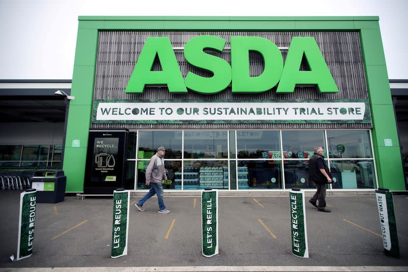 FILE PHOTO: Shoppers walk past the UK supermarket Asda, as the store launches a new sustainability strategy, in Leeds