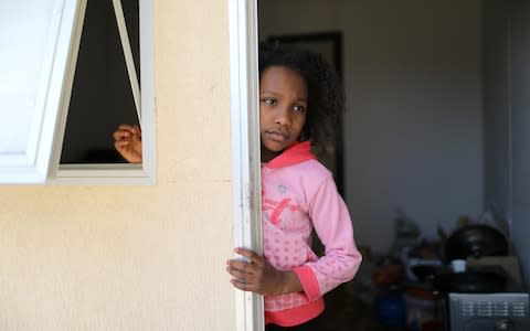 A Libyan girl who fled her home in Tripoli with her family as a result of the fighting - Credit: Reuters