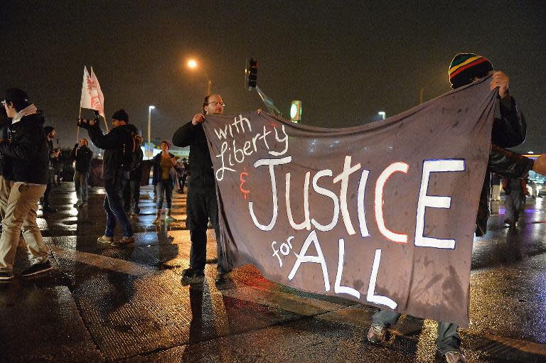 Demonstrators take to the streets in St. Louis, Missouri on November 23, 2014, stepping up pressure on a grand jury to indict a white police officer for shooting dead an unarmed black teenager