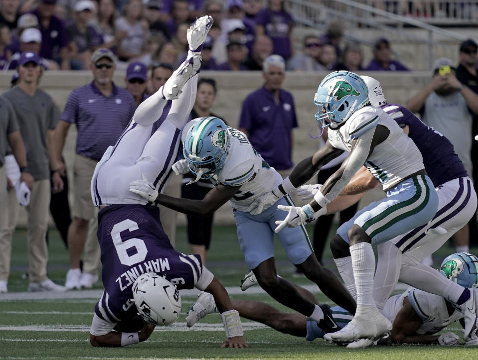 Kansas State quarterback Adrian Martinez (9) is tackled by Tulane cornerback Bailey Despanie (32) during the second half of an NCAA college football game Saturday, Sept. 17, 2022, in Manhattan, Kan. Tulane won 17-10. (AP Photo/Charlie Riedel)