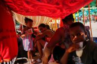 Migrants wait as they hope to obtain humanitarian visas to transit Mexican territory, in Tapachula