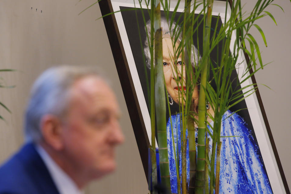 Lord Mayor of the City of London Peter Estlin speaks in front of the portrait of the Britain's Queen Elizabeth II during a news conference in Hong Kong, Tuesday, Feb. 19, 2019. Estlin paid an official visit to Hong Kong from Feb. 18 to 19 to reinforce the UK's links with cities across Asia. (AP Photo/Kin Cheung)