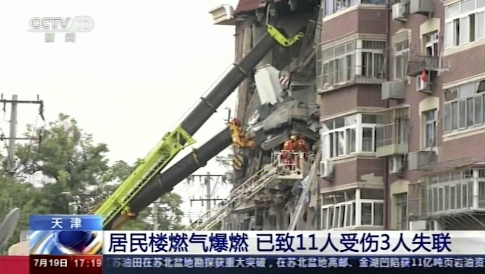 In this image taken from video footage run by China's CCTV, an aerial shot shows a partially collapsed building in the eastern Chinese port city of Tianjin, Tuesday, July 19, 2022. A gas explosion and the partial building collapse, left some people missing and others injured. (CCTV via AP)