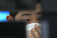 A currency trader watches monitors at the foreign exchange dealing room of the KEB Hana Bank headquarters in Seoul, South Korea, Thursday, Sept. 23, 2021. Asian shares were mostly higher on Thursday after the Federal Reserve signaled it may begin easing its extraordinary support measures for the economy later this year.(AP Photo/Ahn Young-joon)